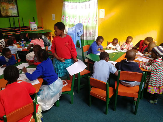 African children in a brightly-painted room